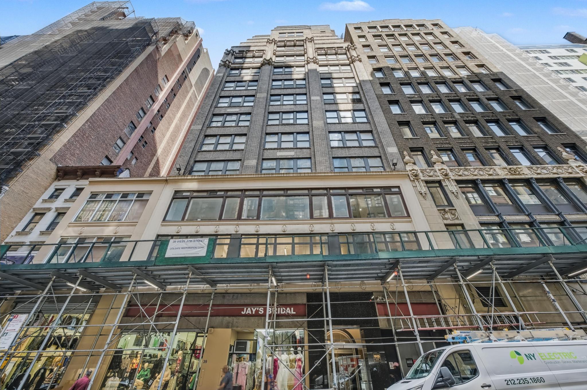 The facade as sent - wrapped in scaffolding and netting